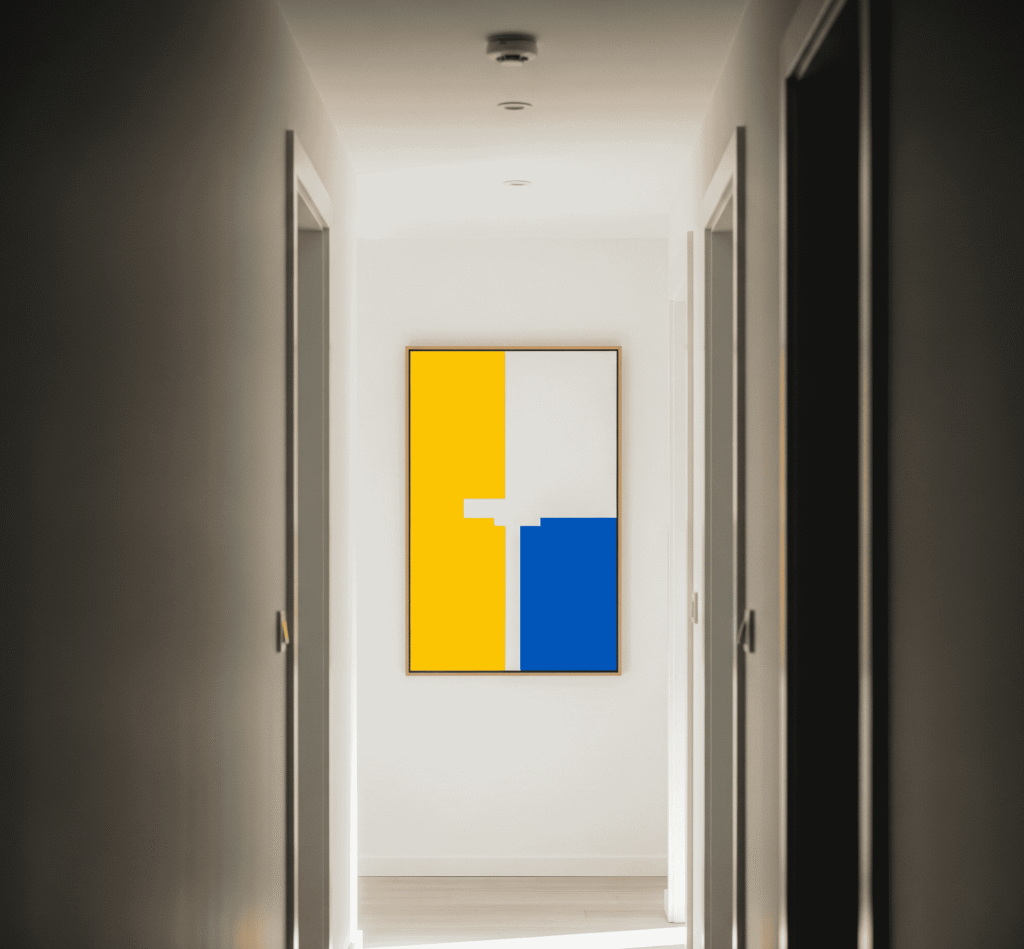 The Best Art for Small Spaces: Tips and Ideas 1 A narrow hallway with a bright, minimal abstract painting adding depth to the space